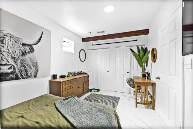 a bedroom with a bed and a couch