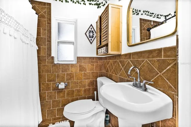 a bathroom with a sink a mirror and a toilet