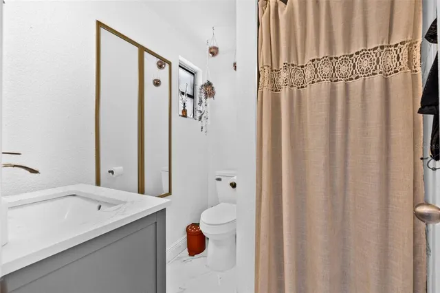 a bathroom with a shower curtain and a sink