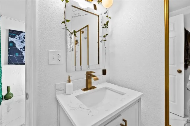 a bathroom with a sink vanity and a mirror