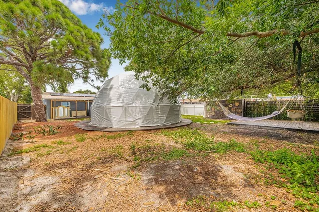 a backyard of a house with table and chairs