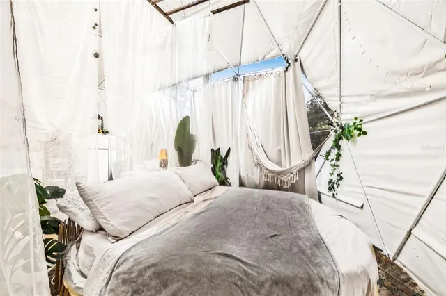 a bedroom with bed and a chandelier