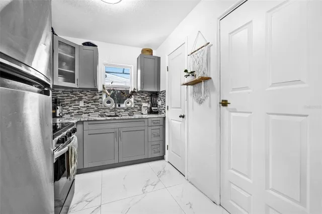 a bathroom with a sink and a refrigerator