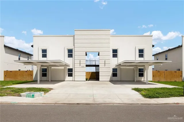 a view of a white house with a swimming pool