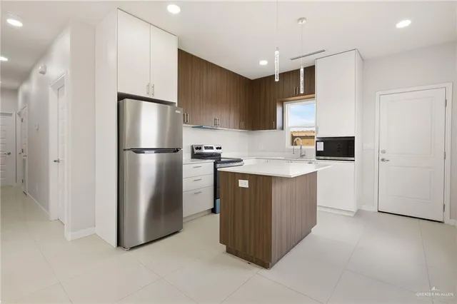 a kitchen with stainless steel appliances a refrigerator and a stove