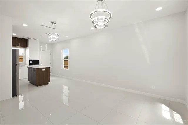 a view of a kitchen with refrigerator and windows