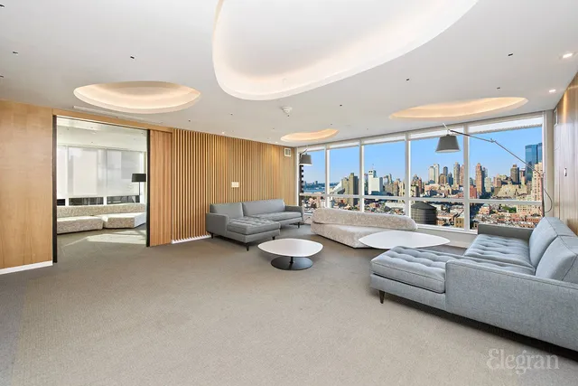 a room with lots of white furniture and a table