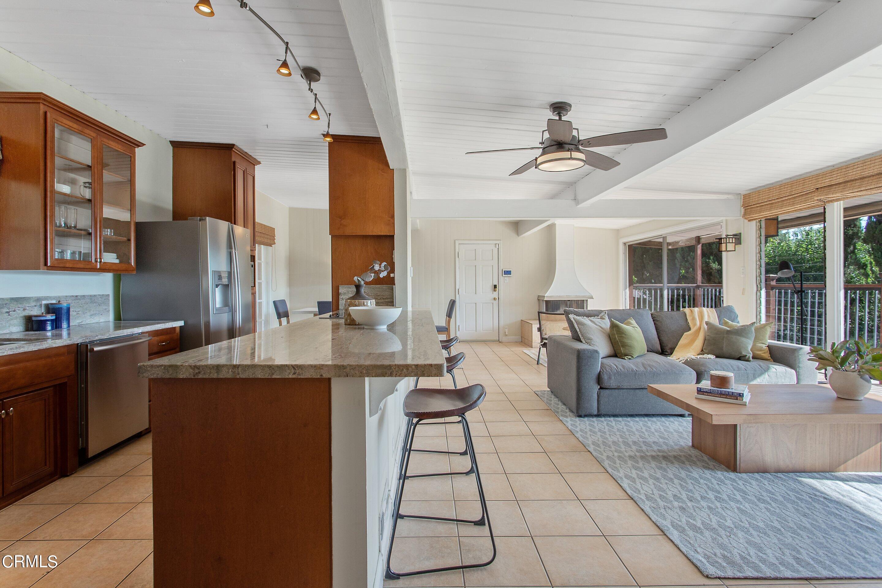 3170 Buckingham Road Glendale, CA 91206 - Photo 11 of 47 a living room with couches and kitchen view with wooden floor