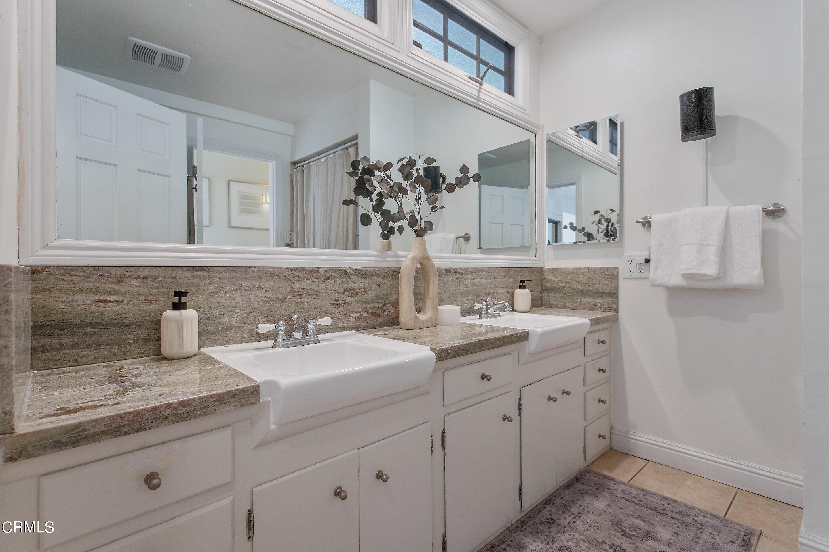 3170 Buckingham Road Glendale, CA 91206 - Photo 16 of 47 a bathroom with a granite countertop sink and a mirror