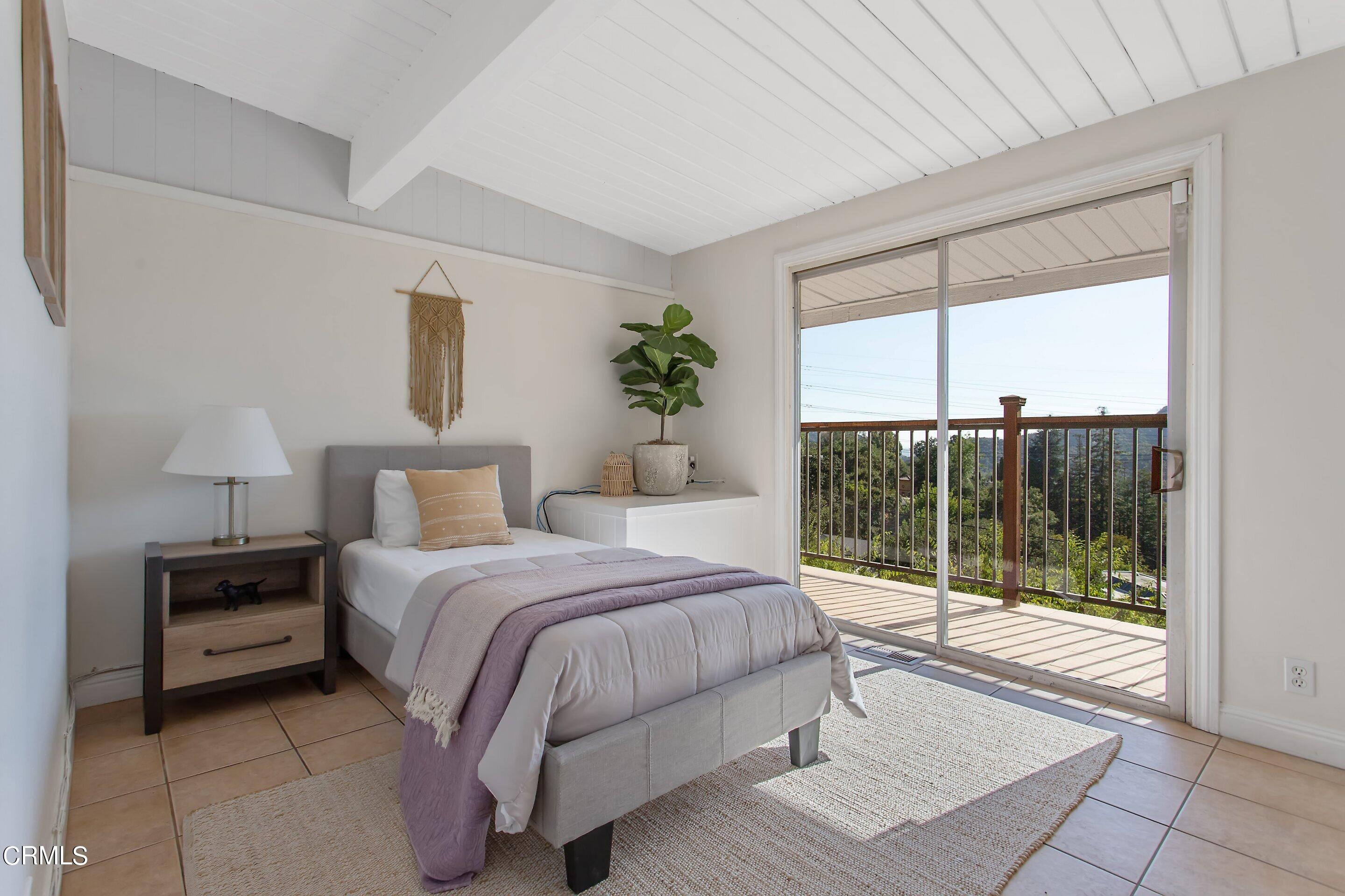 3170 Buckingham Road Glendale, CA 91206 - Photo 18 of 47 a bedroom with a bed lamp and window
