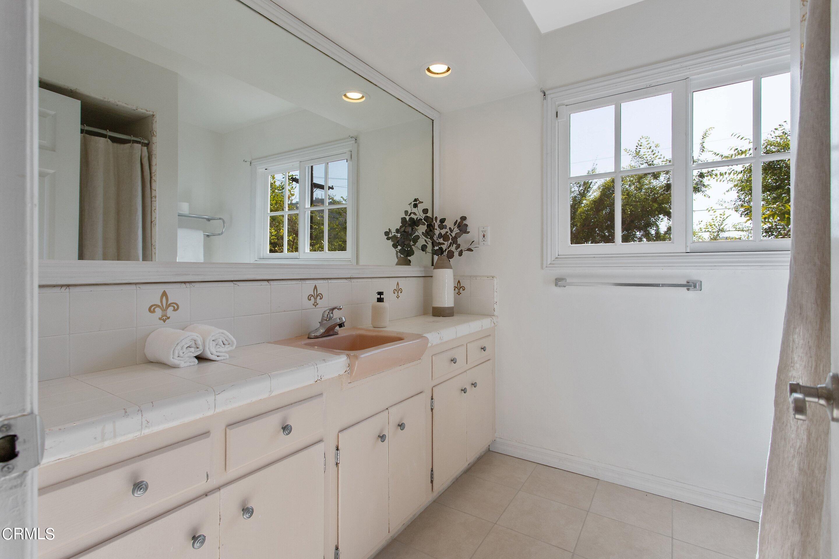 3170 Buckingham Road Glendale, CA 91206 - Photo 36 of 47 a bathroom with a double vanity sink window and mirror