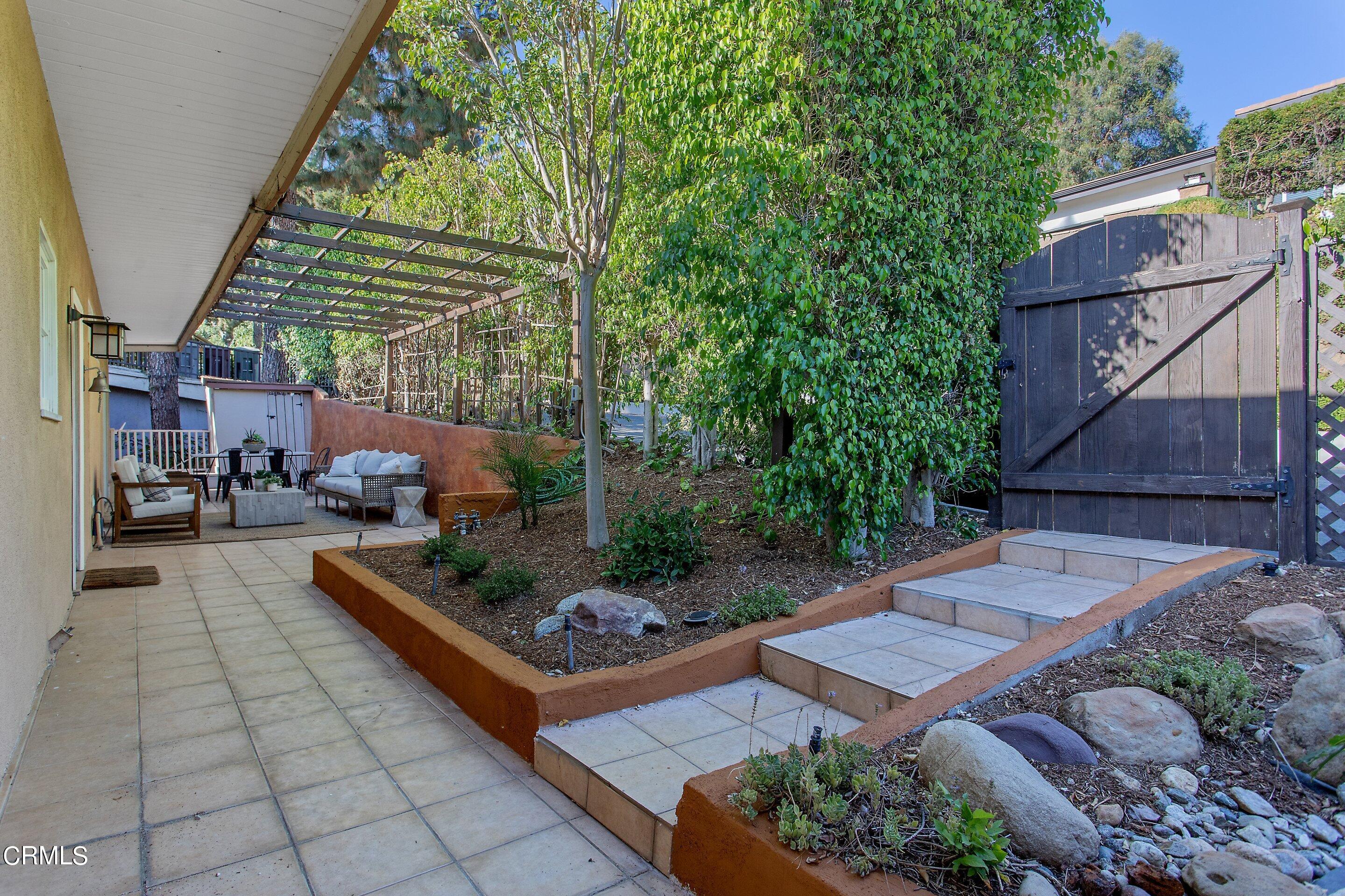 3170 Buckingham Road Glendale, CA 91206 - Photo 41 of 47 a view of a patio with table and chairs potted plants