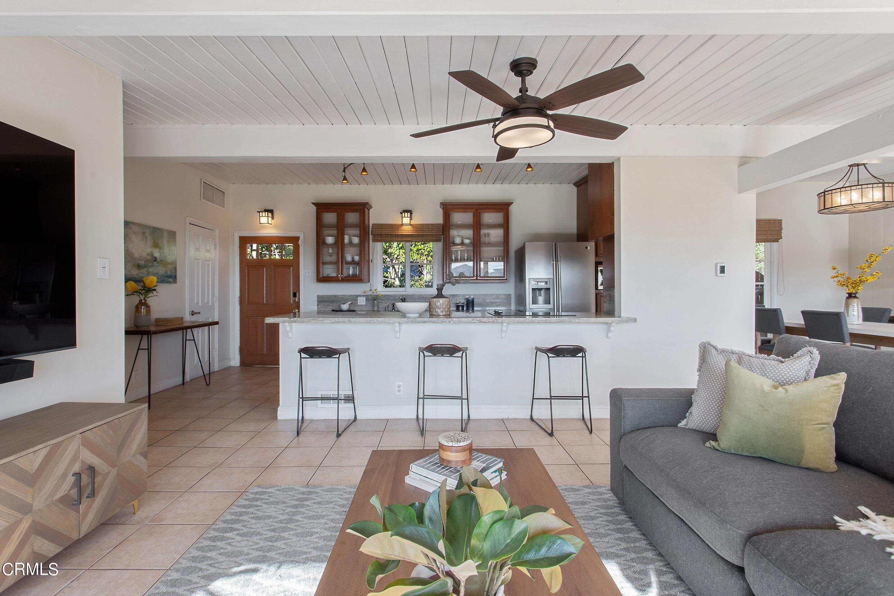 3170 Buckingham Road Glendale, CA 91206 - Photo 7 of 47 a living room with furniture a ceiling fan and a flat screen tv
