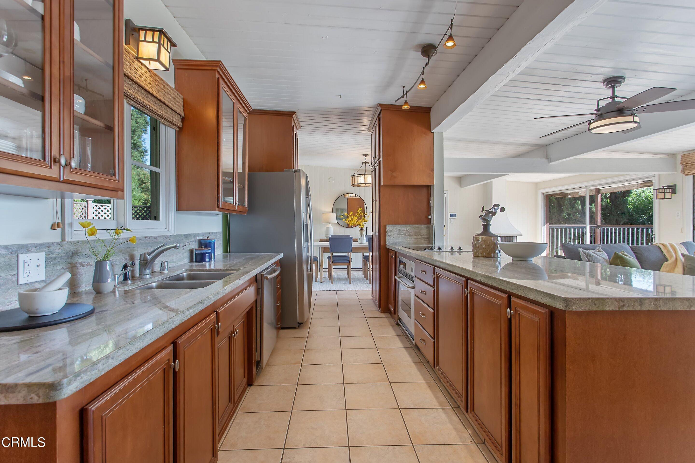 3170 Buckingham Road Glendale, CA 91206 - Photo 8 of 47 a large kitchen with stainless steel appliances granite countertop a sink and cabinets