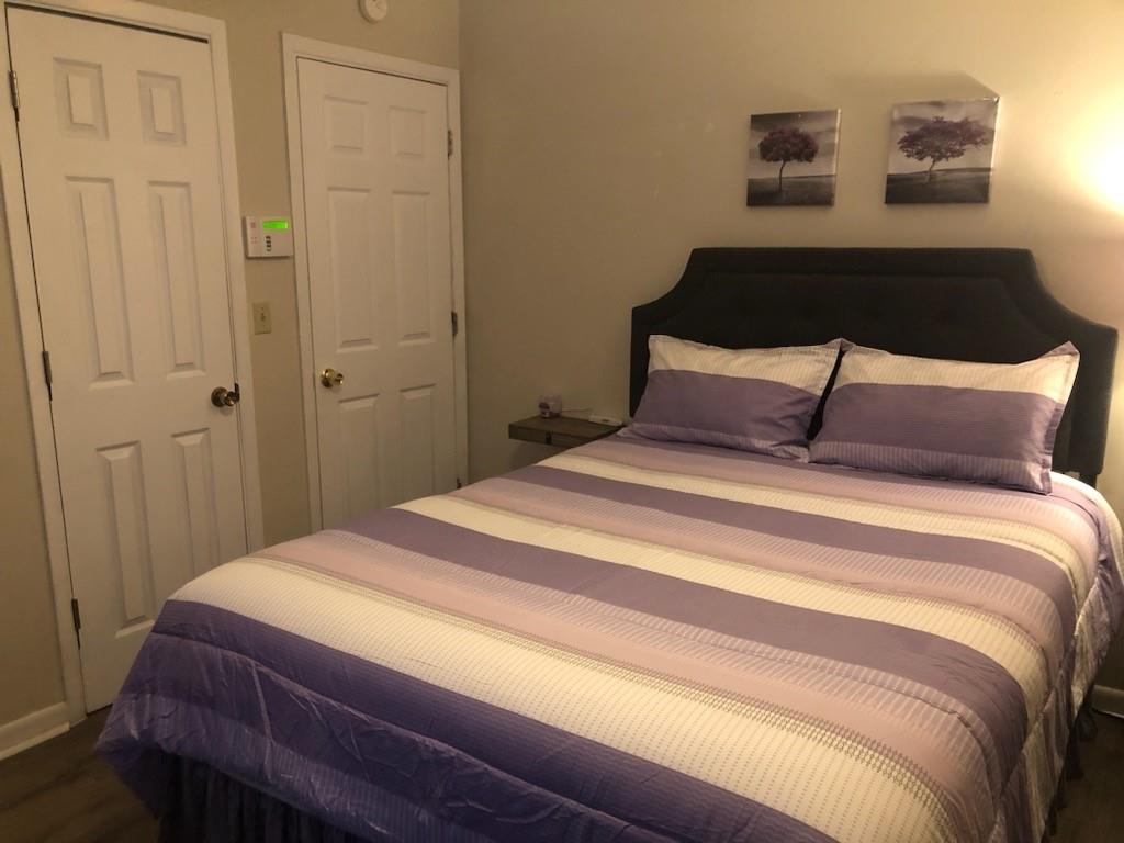 3960 Emerald N Drive Decatur, GA 30035 - Photo 4 of 8 a bedroom with a bed and night stand