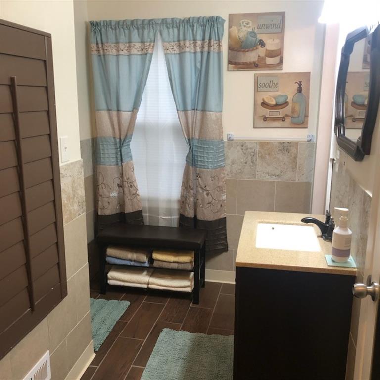 3960 Emerald N Drive Decatur, GA 30035 - Photo 6 of 8 a bathroom with a sink a mirror and a shower