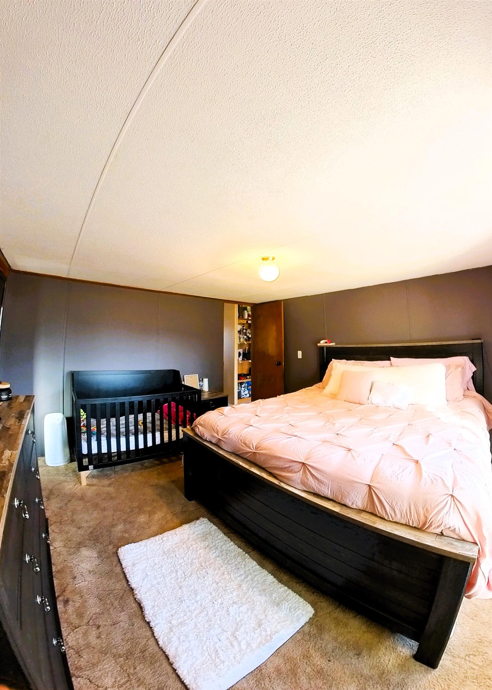 2108 1/2 H Road Fruita, CO 81521 - Photo 23 of 40 a bed sitting in a bedroom next to a lamp