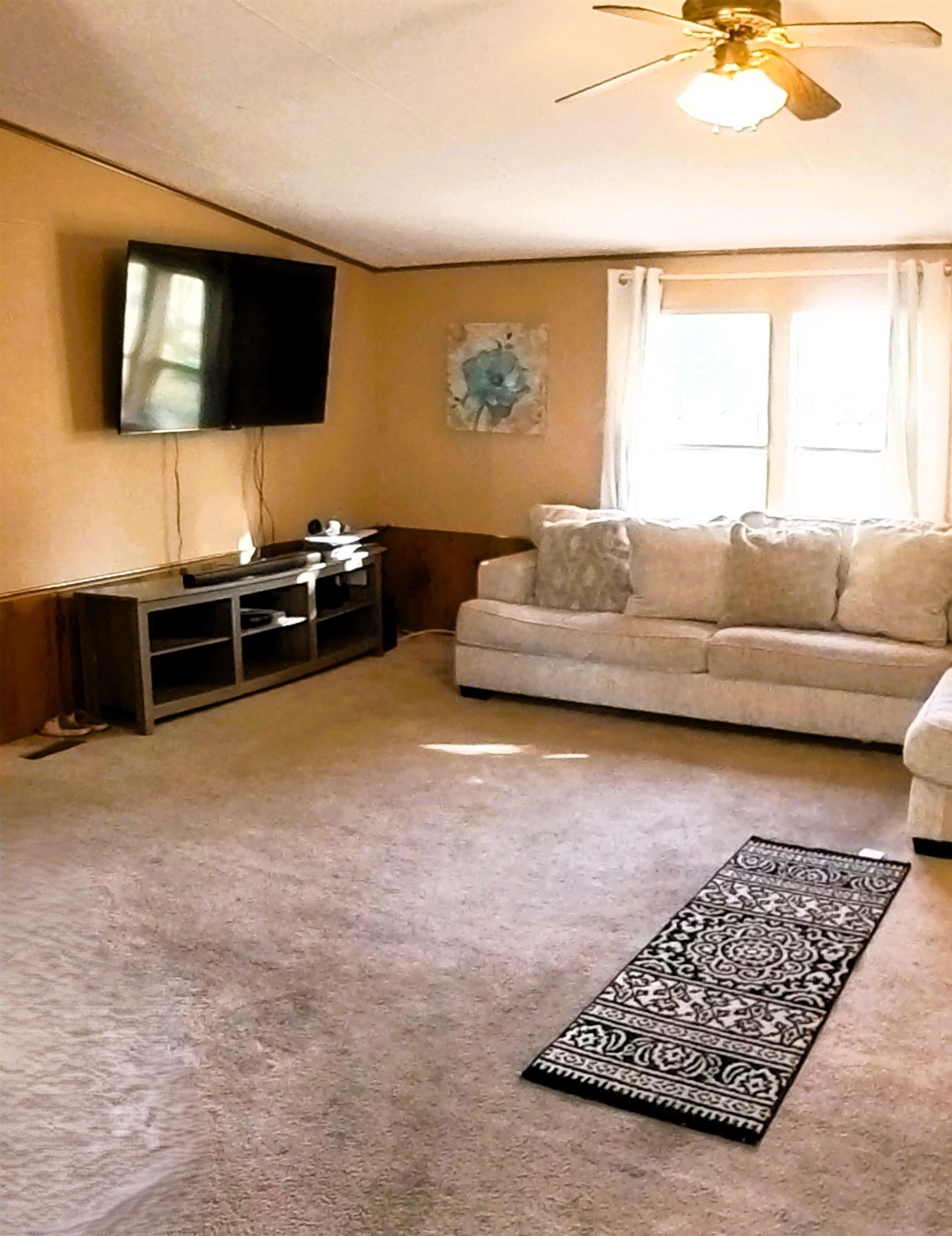 2108 1/2 H Road Fruita, CO 81521 - Photo 34 of 40 a living room with furniture and a flat screen tv