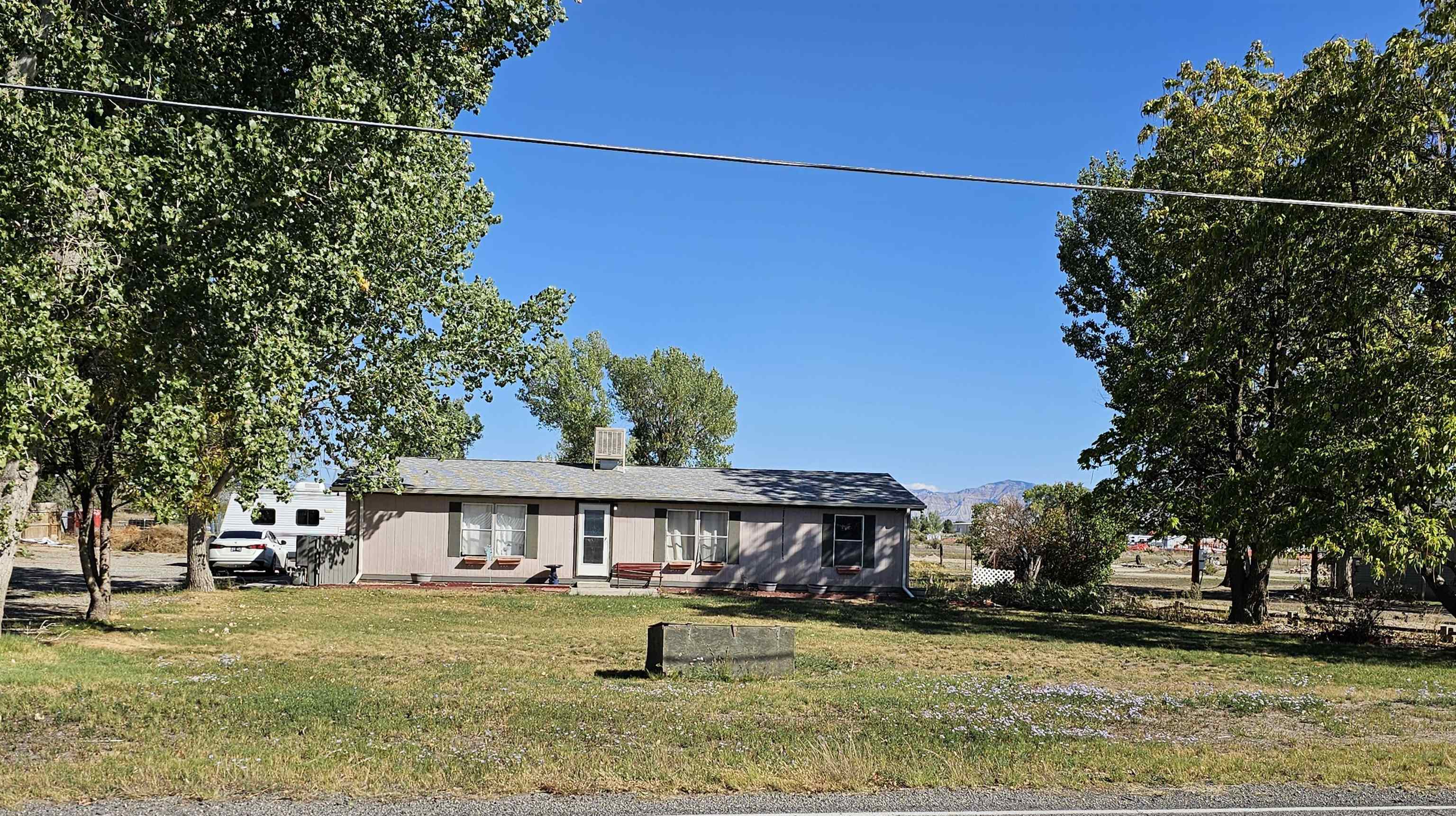 2108 1/2 H Road Fruita, CO 81521 - Photo 4 of 40 a front view of a house with a yard