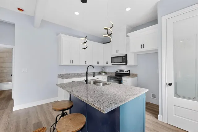 a kitchen with a table chairs and a refrigerator