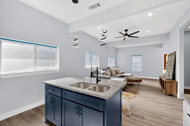 a kitchen with a sink appliances and a large window