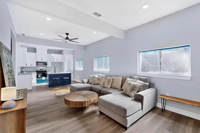 a living room with furniture and wooden floor