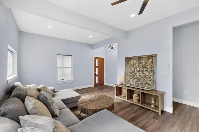 a living room with furniture and wooden floor