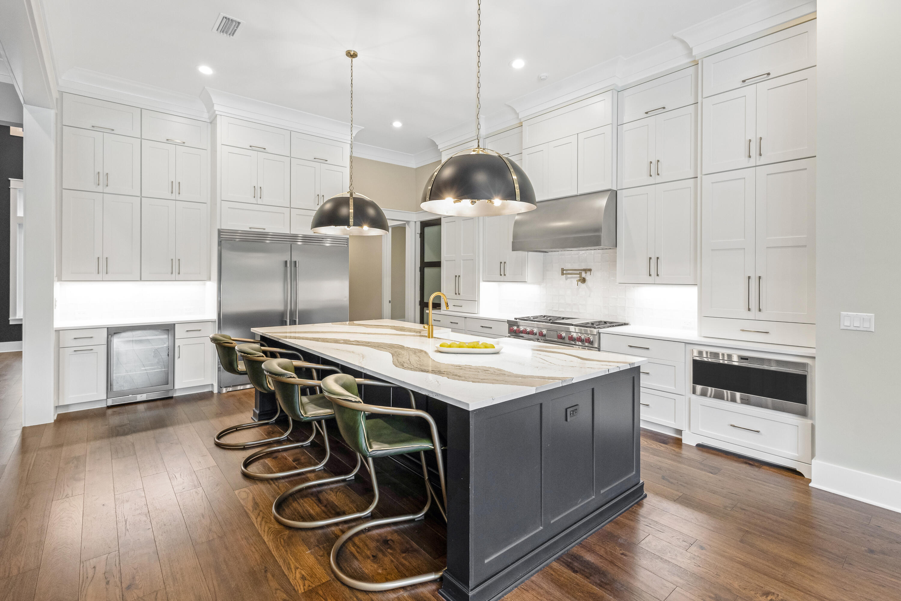 71 Clermont Cove Freeport, FL 32439 - Photo 19 of 73 a kitchen with kitchen island stainless steel appliances a stove a sink a center island and wooden floor