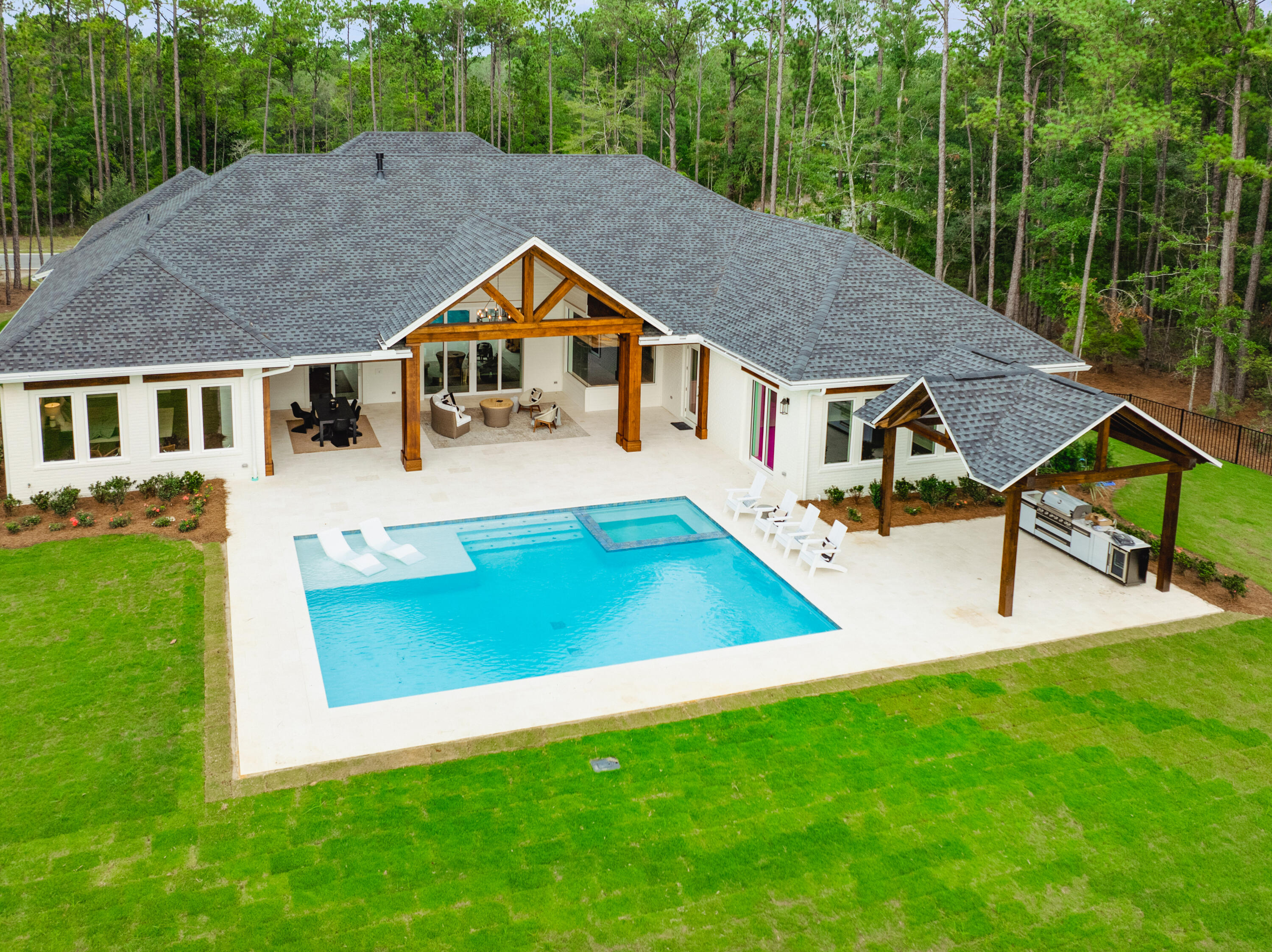 71 Clermont Cove Freeport, FL 32439 - Photo 2 of 73 a aerial view of a house with swimming pool next to a big yard