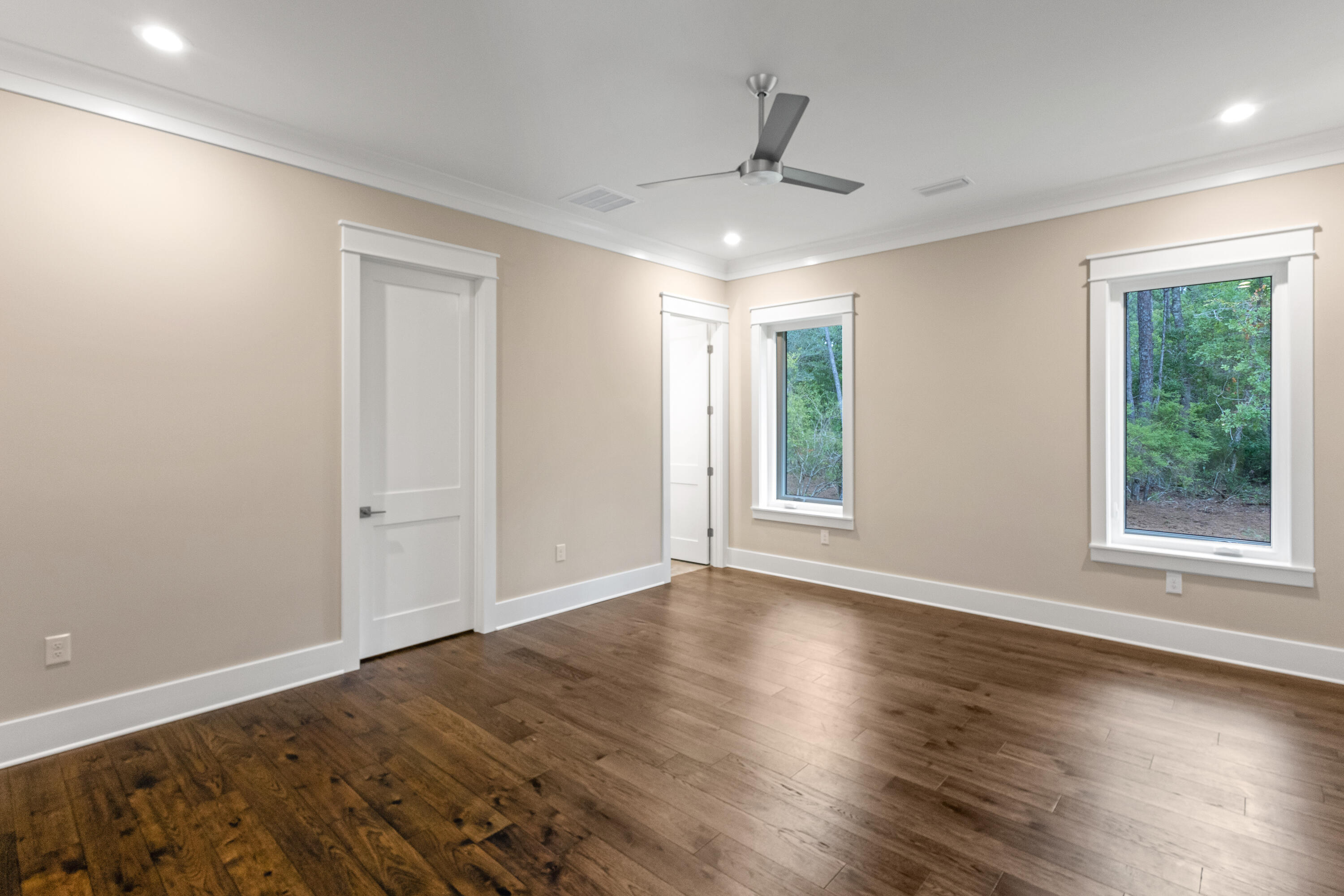 71 Clermont Cove Freeport, FL 32439 - Photo 29 of 73 a view of an empty room with wooden floor and a window