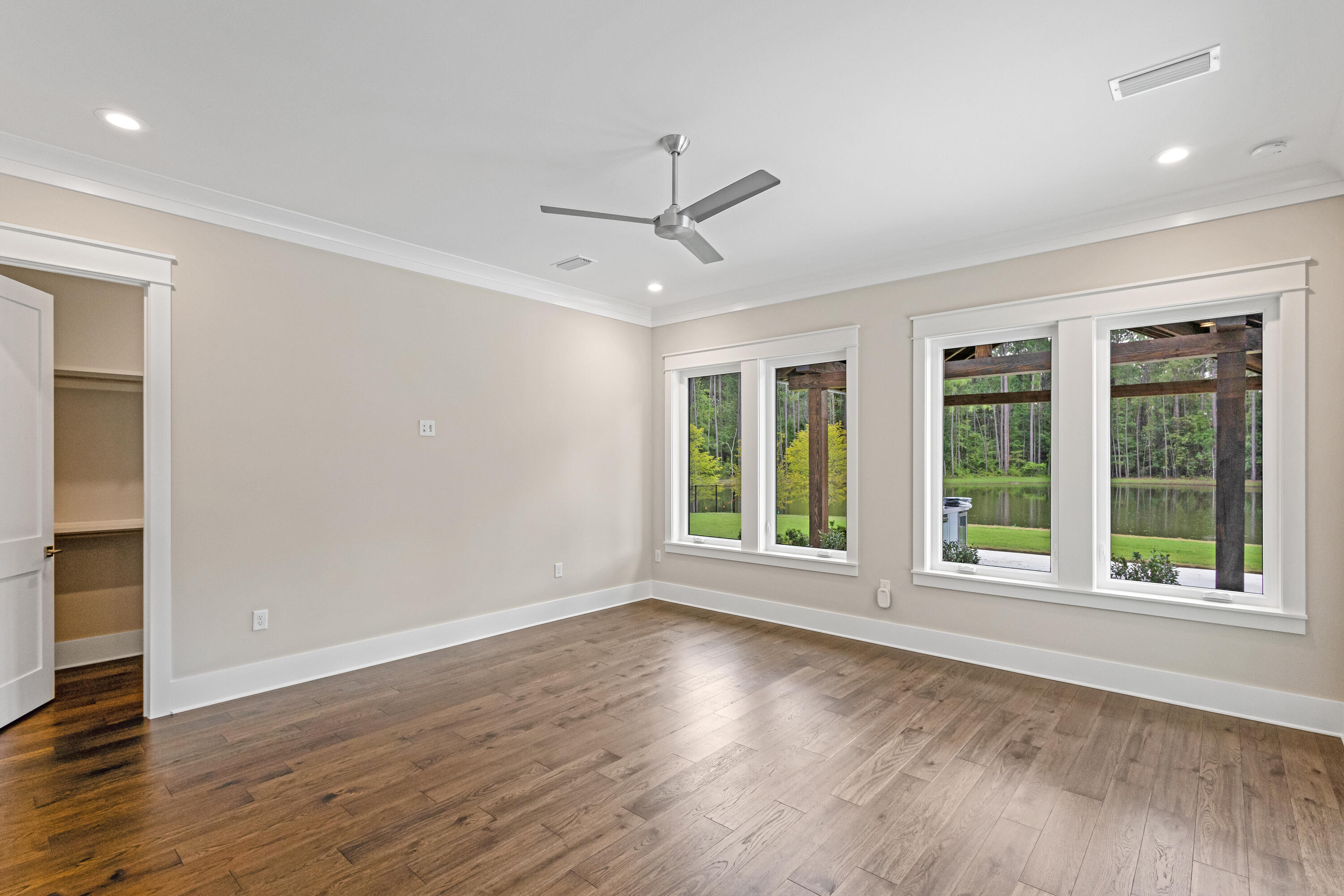 71 Clermont Cove Freeport, FL 32439 - Photo 30 of 73 a view of an empty room with wooden floor and a window