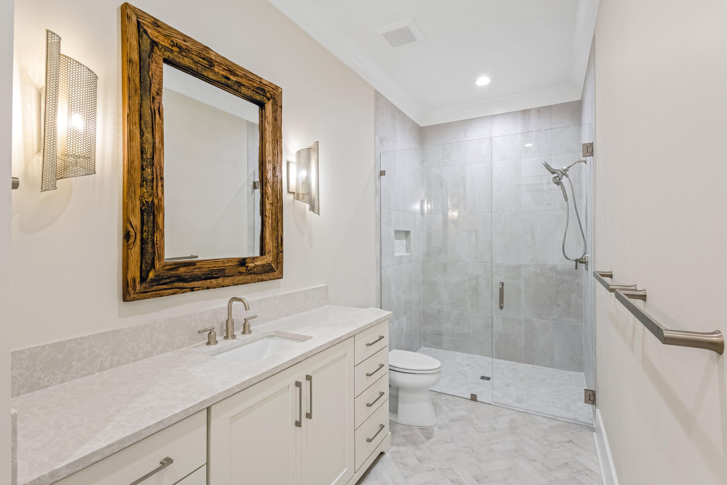 71 Clermont Cove Freeport, FL 32439 - Photo 31 of 73 a bathroom with a double vanity sink toilet mirror and shower