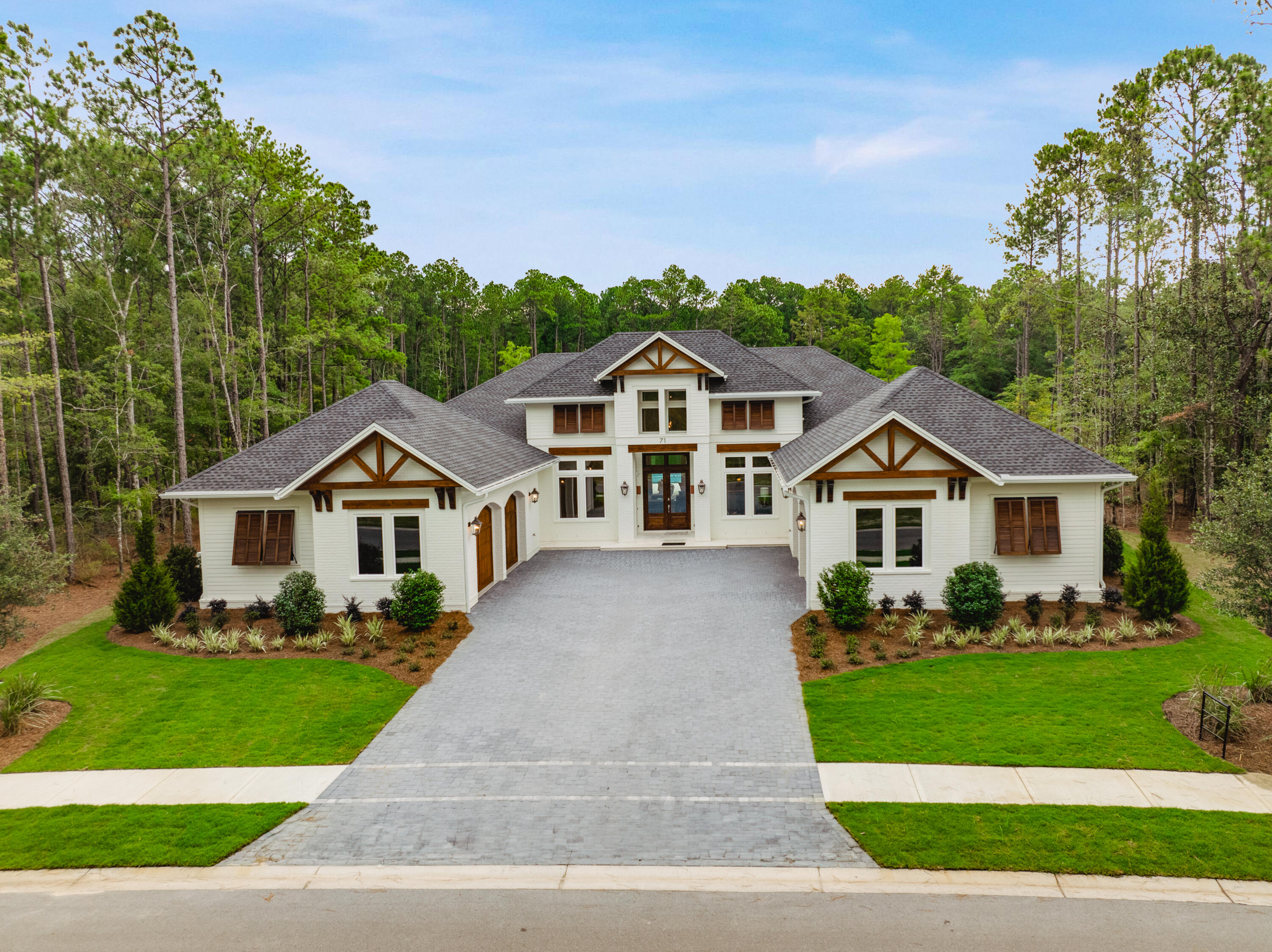 71 Clermont Cove Freeport, FL 32439 - Photo 48 of 73 a front view of a house with a garden and plants