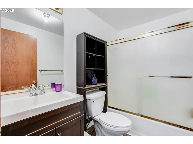 a bathroom with a sink toilet vanity and tub