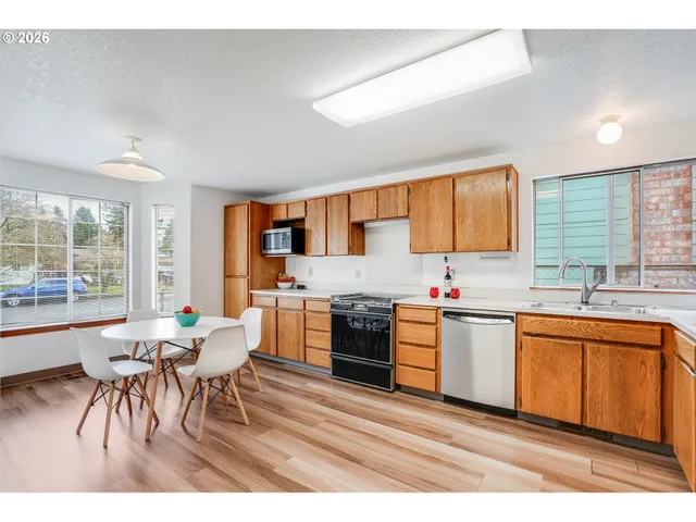 a kitchen with stainless steel appliances kitchen island granite countertop a sink and cabinets