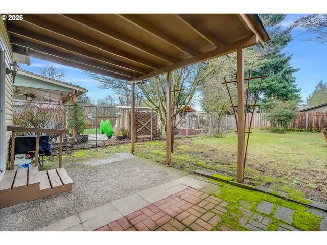 a view of a backyard with table and chairs and potted plants