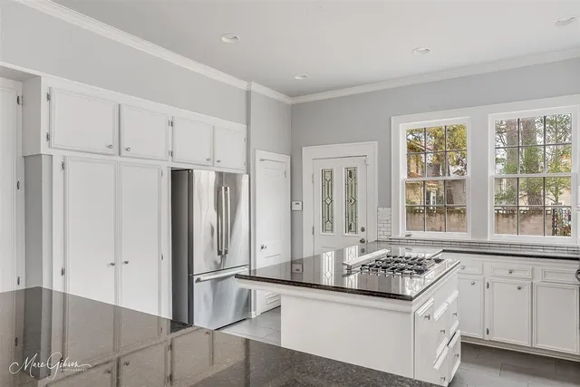 a kitchen with stainless steel appliances granite countertop a refrigerator and a sink