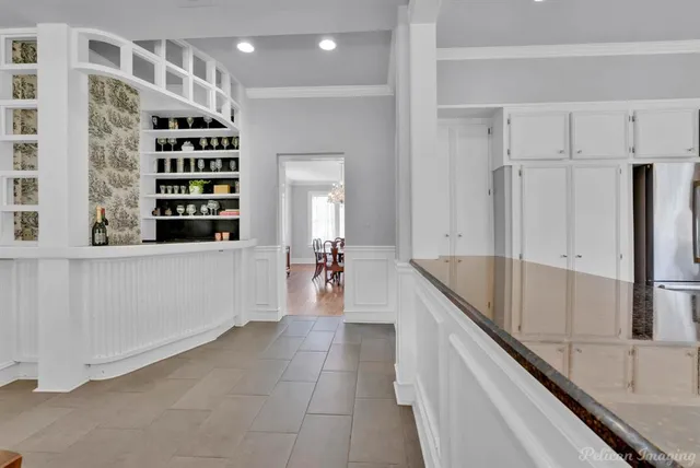 a kitchen with granite countertop a refrigerator and a sink