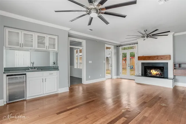 a view of an empty room with a fireplace and a window