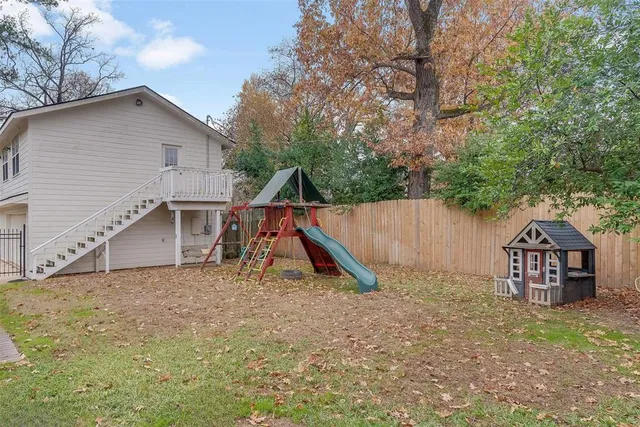 a view of outdoor space with playground and green space