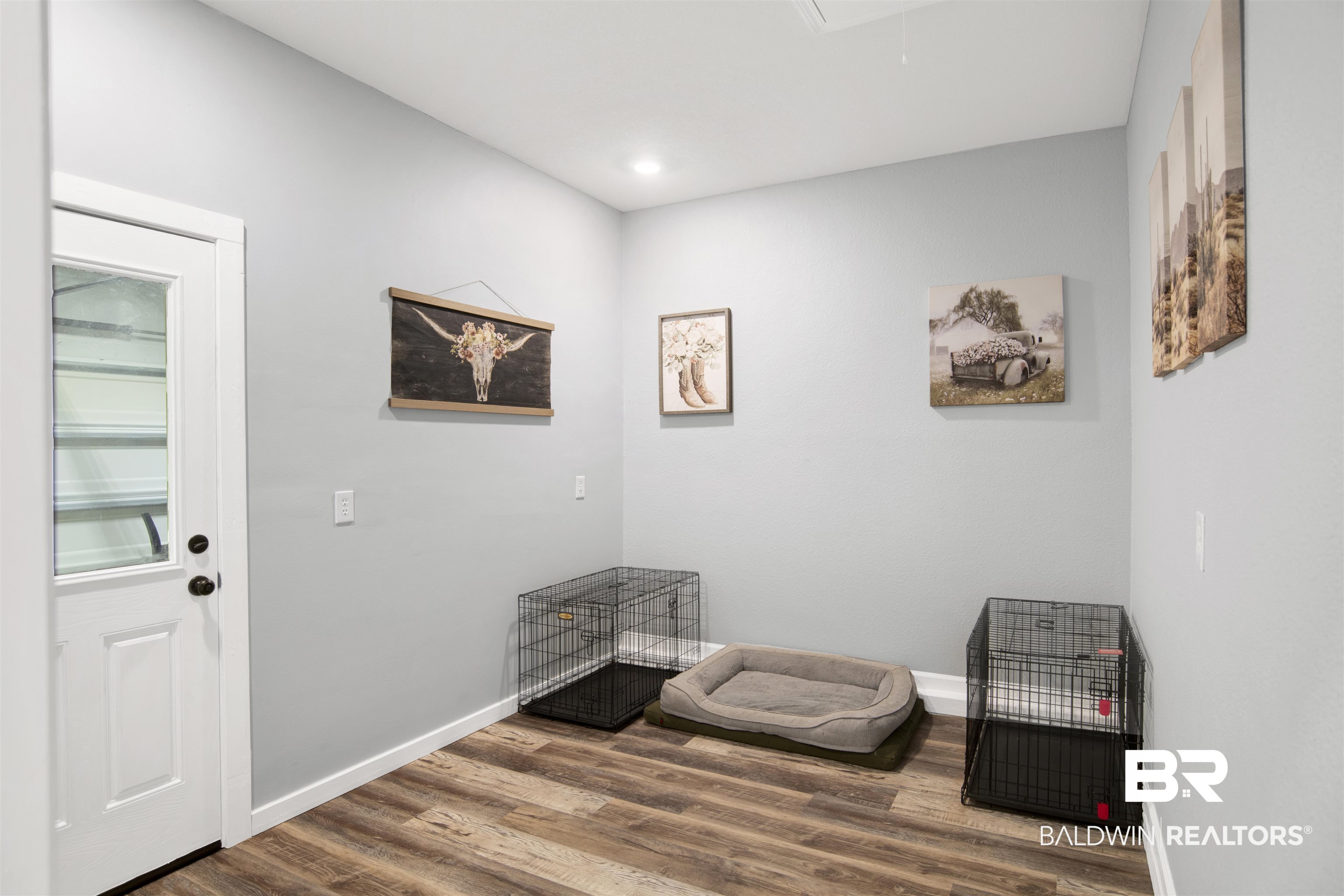 12813 Patriot Way Daphne, AL 36527 - Photo 15 of 23 Interior room featuring wood-finish flooring, light gray walls, white trim, recessed lighting, and a white door with a clear glass panel