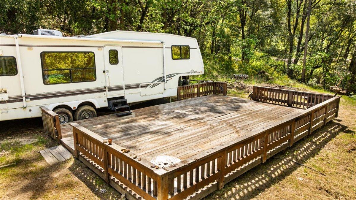 12921 Slate Creek Road Nevada City, CA 95959 - Photo 3 of 41 a view of a roof deck with wooden fence and a couple of chairs