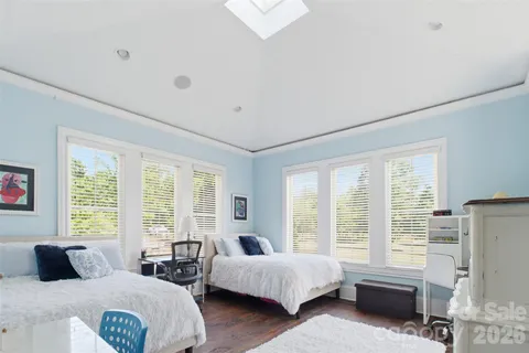 a bedroom with two beds and large window