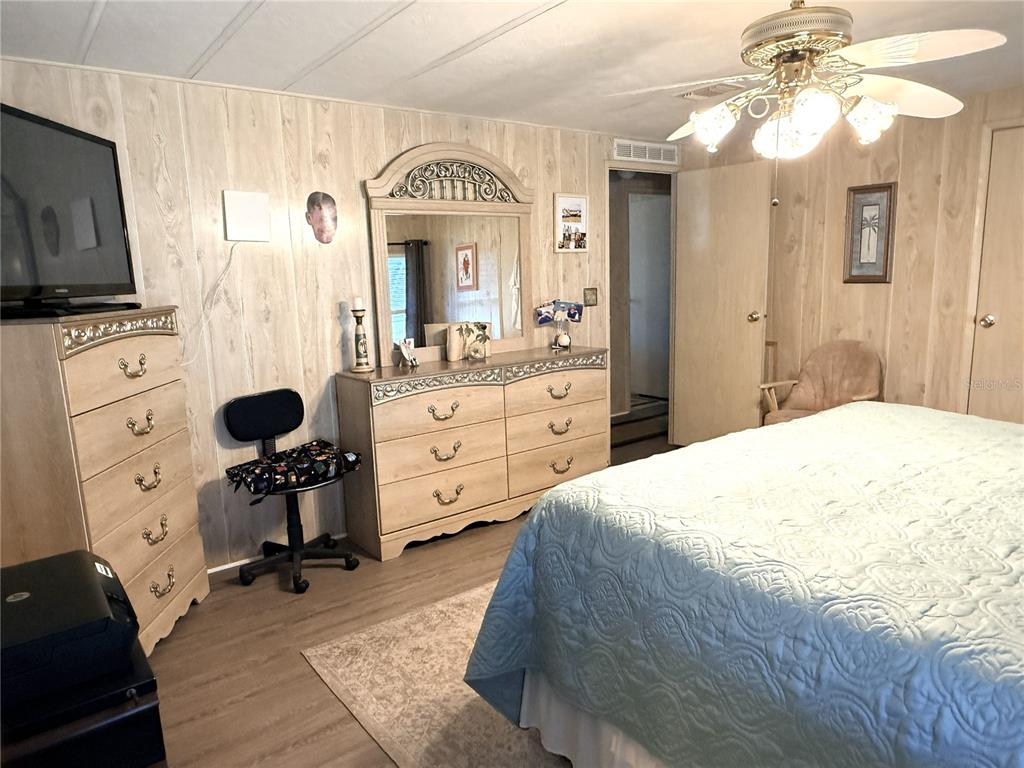 4418 Brave Lane St. Cloud, FL 34772 - Photo 15 of 29 a bedroom with a bed and a chandelier