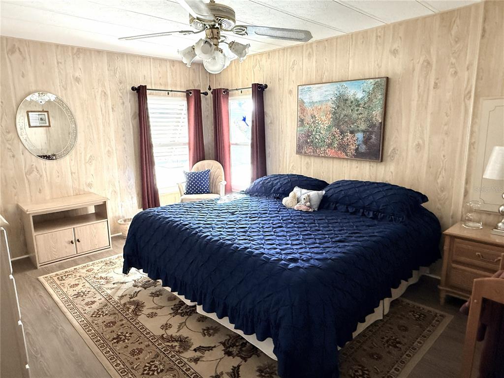 4418 Brave Lane St. Cloud, FL 34772 - Photo 18 of 29 a bedroom with a bed mirror and window