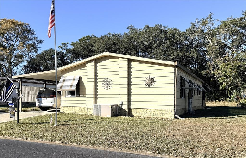 4418 Brave Lane St. Cloud, FL 34772 - Photo 2 of 29 a view of a house with a yard