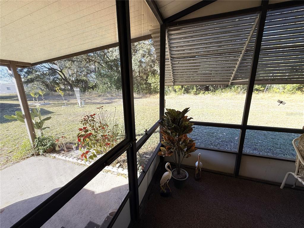 4418 Brave Lane St. Cloud, FL 34772 - Photo 24 of 29 a view of a floor to ceiling window with a tree