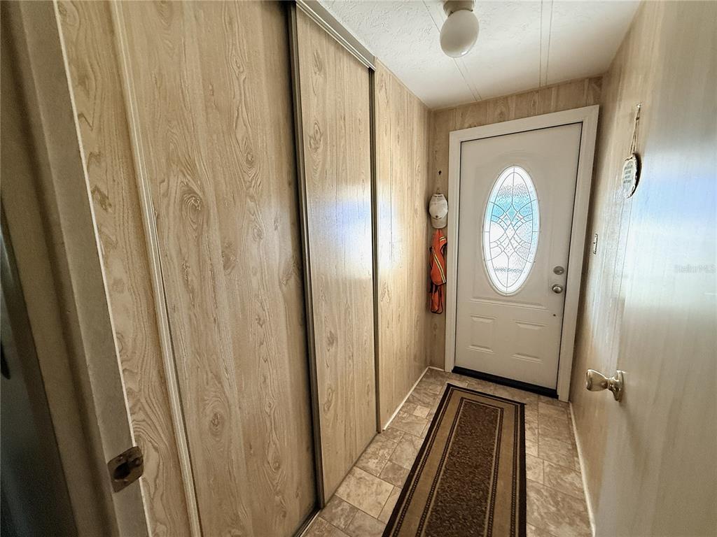 4418 Brave Lane St. Cloud, FL 34772 - Photo 4 of 29 a view of a hallway with wooden floor