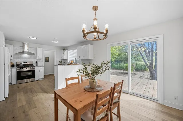 a view of a dining room with furniture wooden floor and chandelier
