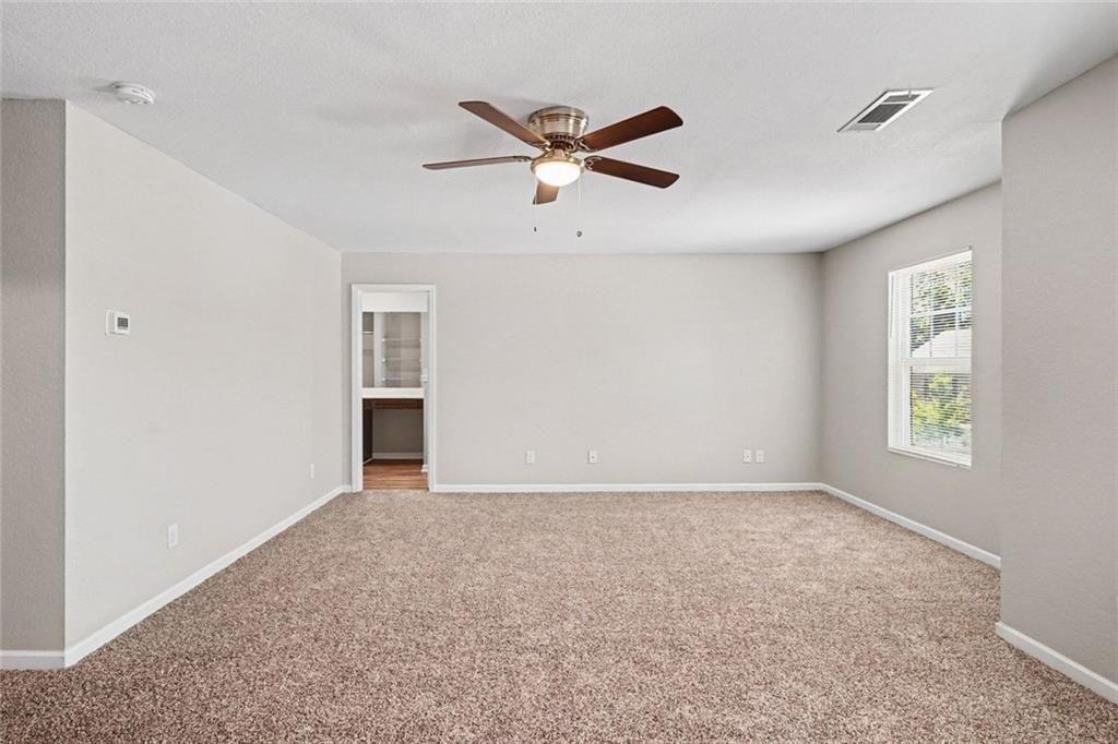 10941 Wheeler Trace Hampton, GA 30228 - Photo 9 of 21 a view of empty room with window and ceiling fan